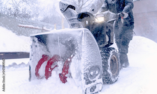 the janitor cleans the snow with a snowplow