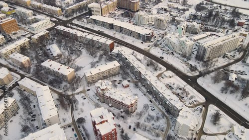 Aerial view of an urban sleeping area in winter, everything is covered with snow. New buildings in a modern metropolis. Solution of the housing problem. City of Vladimir, Oktyabrsky district. UHD 4K. photo