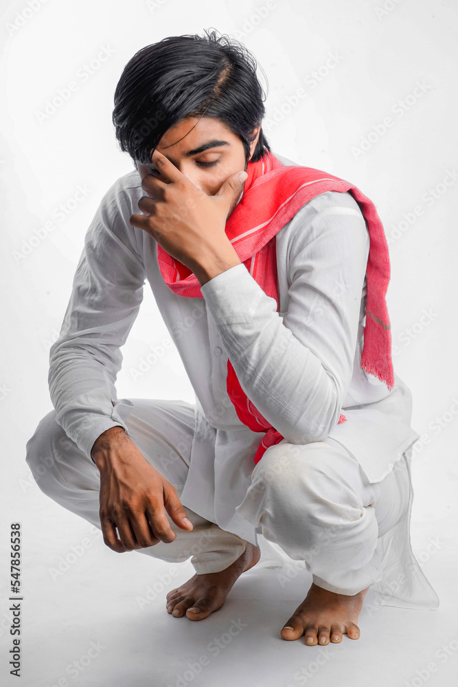 indian young farmer sitting on white background indian young farmer sitting on white background