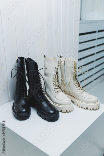 Fashionable women's stylish leather boots. Women's leather boots on the floor. New collection of winter shoes for stylish girls.