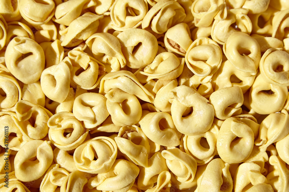 Tortellini pasta with prosciutto, food background, top view. Italian stuffed pasta Tortellini pasta with prosciutto, food background, top view. Italian stuffed pasta