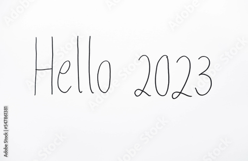 Handmade writing on the white wall, Hello 2023