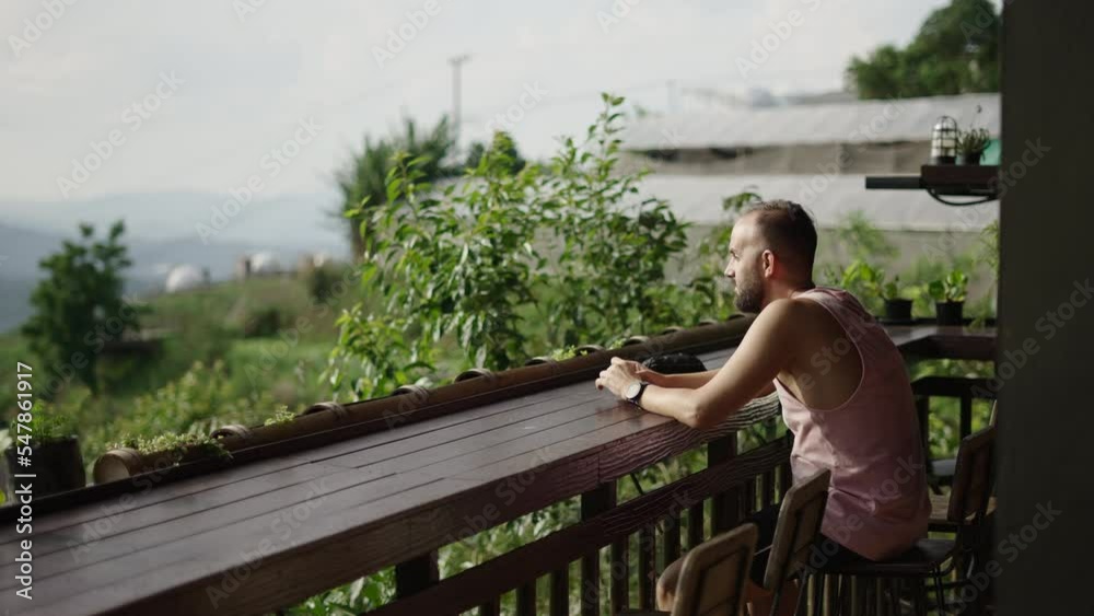 Spanish adult man watching the sunset from a terrace in Chiang Mai Spanish adult man watching the sunset from a terrace in Chiang Mai