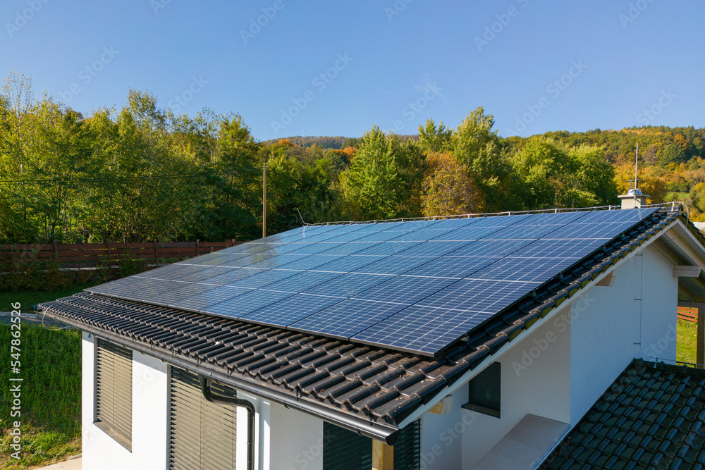 High angle view of solar photovoltaic panels on roof, alternative energy, saving resources and sustainable lifestyle concept.