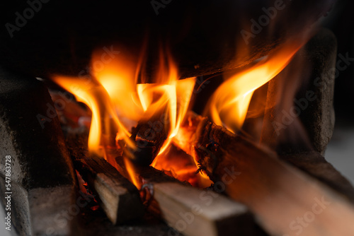 Flames burning high in a charcoal stove,Fire flames background.Add firewood to increase the power of fire.