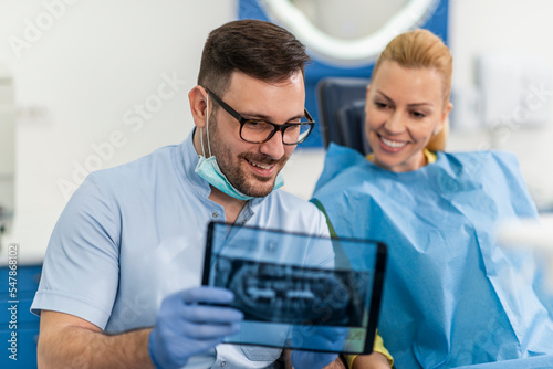 Doctor showing patient's teeth on x-ray