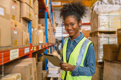 Fotografija woman worker black African girl teen working in cargo warehouse inventory employ