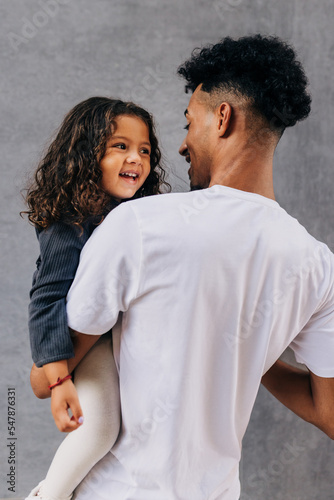 Dad celebrating father's day with his adorable daughter in a studio