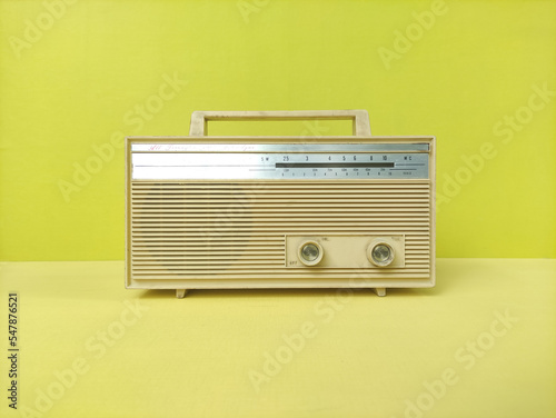 old transistor radio on yellow table
