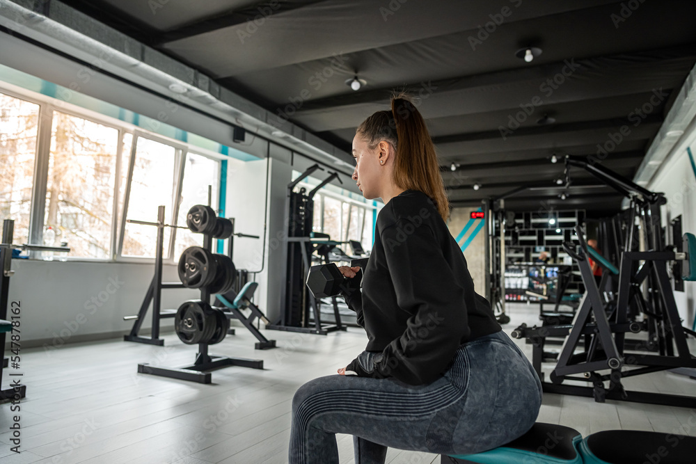 attractive young woman works on her own body and does fitness in a sports club. attractive young woman works on her own body and does fitness in a sports club.
