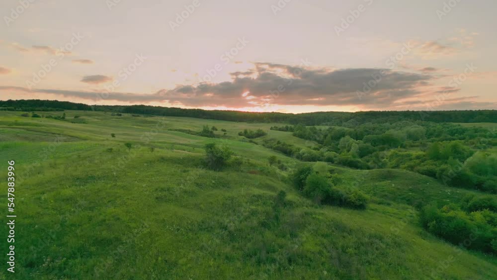grassy hills taken from a height against the sunset sky grassy hills taken from a height against the sunset sky