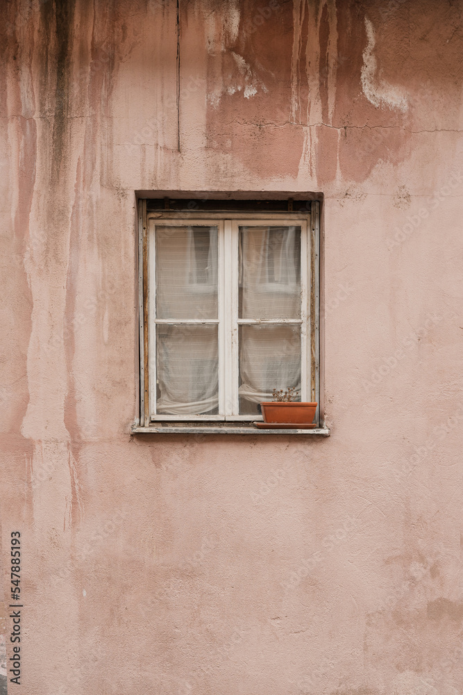 Pink coral wall and wooden window. Traditional European old town building. Old historic architecture in Nuremberg, Germany