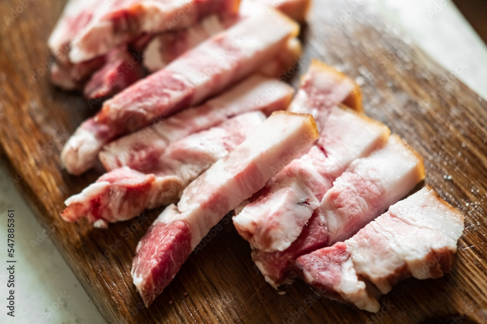 Bacon sliced on a wooden board. Salo with meat.