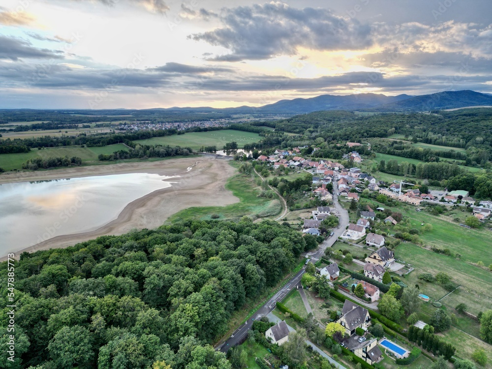 Panoramic aerial drone top view of the village of Michelbach (Upper-Rhine, Alsace, France) and his lake
