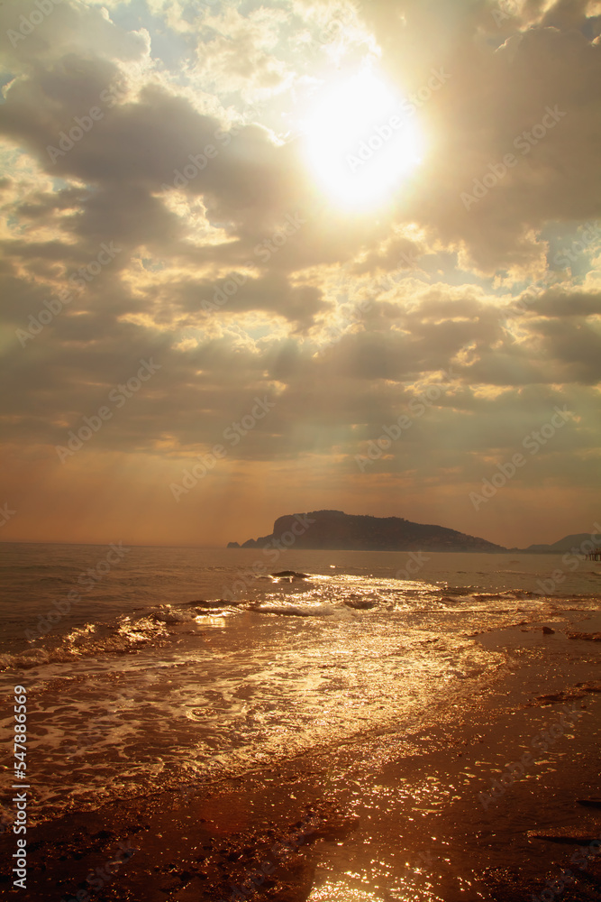 Vertical image of sunset on the Mediterranean Sea. Beautiful evening seascape of the tourist cities in Turkey, Alanya.