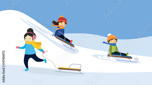 Three children sledding down a hill