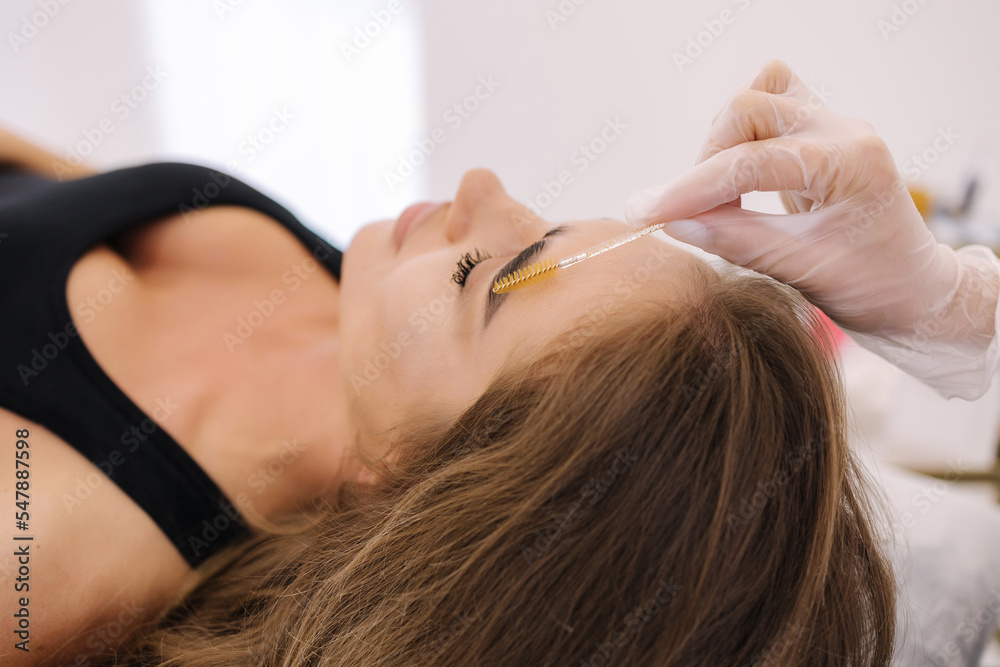 Beautiful female model lying on the couch and waiting for eyelash and brow lamination procedure in beauty salon Beautiful female model lying on the couch and waiting for eyelash and brow lamination procedure in beauty salon