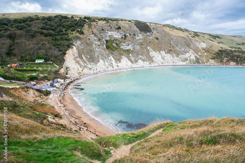 Beautiful views of Lulworth Cove in Dorset, United Kingdom. Part of Jurassic Coast World Heritage Site, view of stone cliffs and blue sea, selective focus