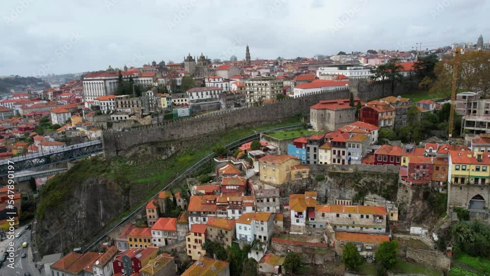 Descending aerial shot showing important landmarks within Porto, Portugal, as Funicular dos Guindais and Muralha Fernandina Descending aerial shot showing important landmarks within Porto, Portugal, as Funicular dos Guindais and Muralha Fernandina