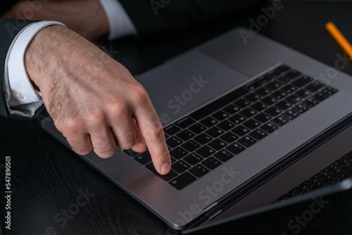 Businessman wearing formal suit is sitting pressing button with finger