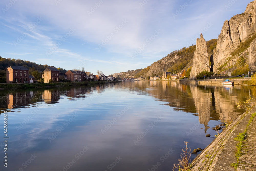 Rocher Bayard with its reflection on the Meuse river in Dinant, Belgium