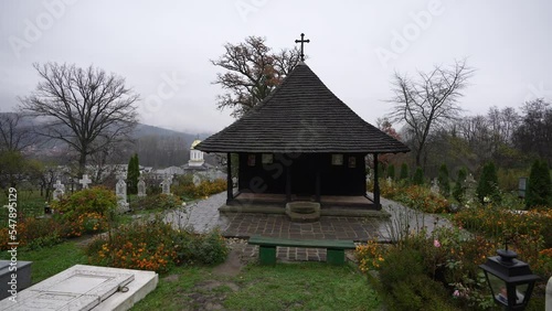 Wide angle 4K video with this church from Valcea county. One wood church monastery (Biserica dintr-un lemn in Romanian language) landmark from Romania, 2022. photo
