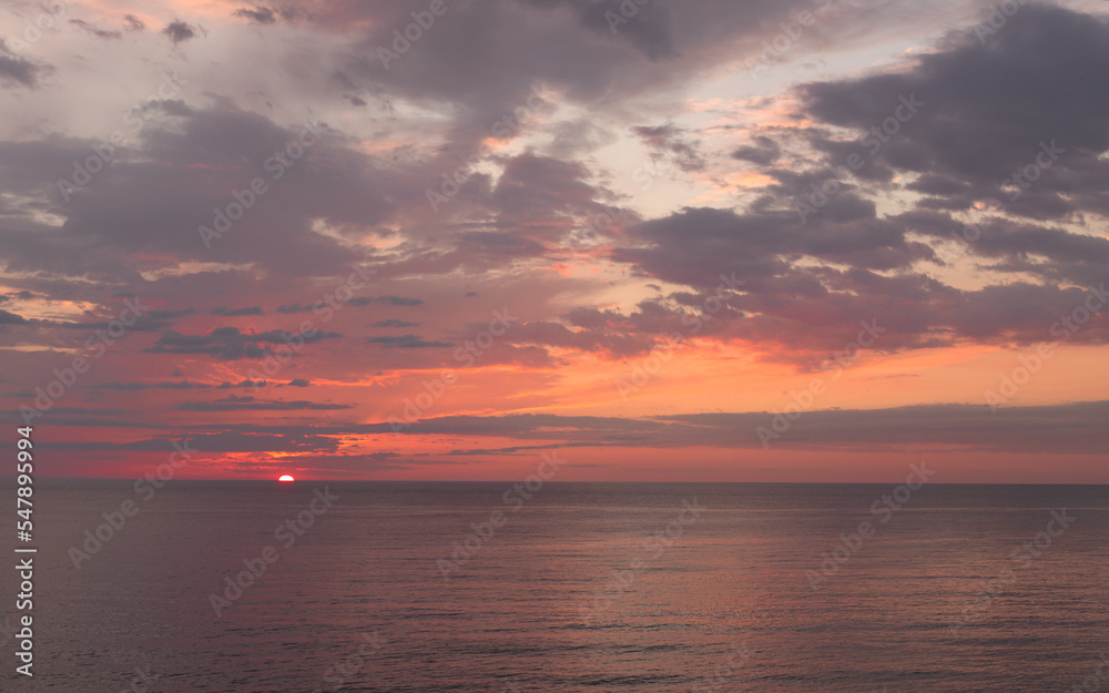 Calm sea with sunset sky with cloud.