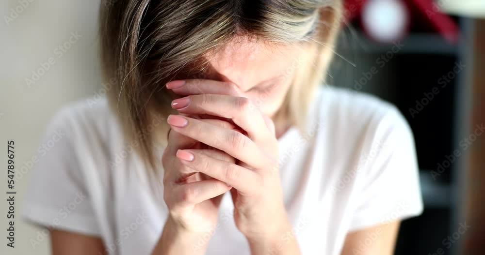 Closeup of hands of gloomy young woman holding hands and feeling sad Closeup of hands of gloomy young woman holding hands and feeling sad