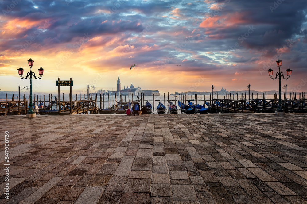 Panoramic sunrise view of the Gondolas at the empty St. Mark's Square and with San Giorgio Maggiore in the background, Venice, Italy