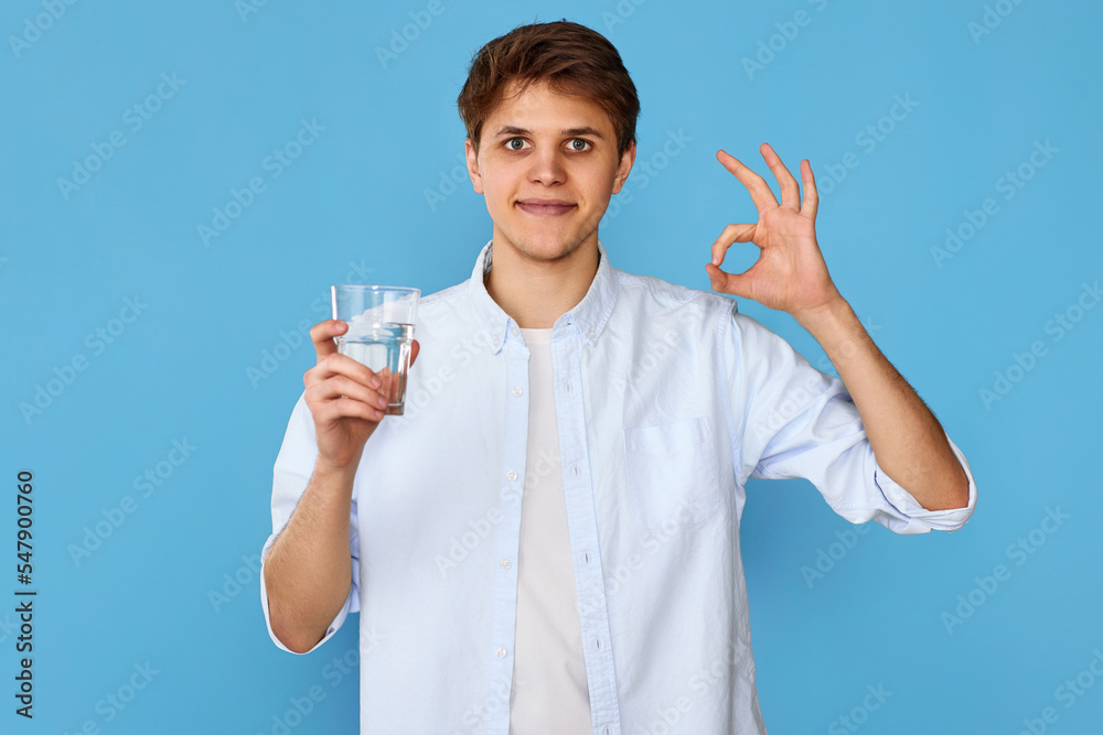 Young handsome man with drinking glass of water Young handsome man with drinking glass of water