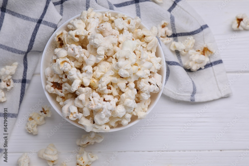 Tasty popcorn on white wooden table, flat lay Tasty popcorn on white wooden table, flat lay