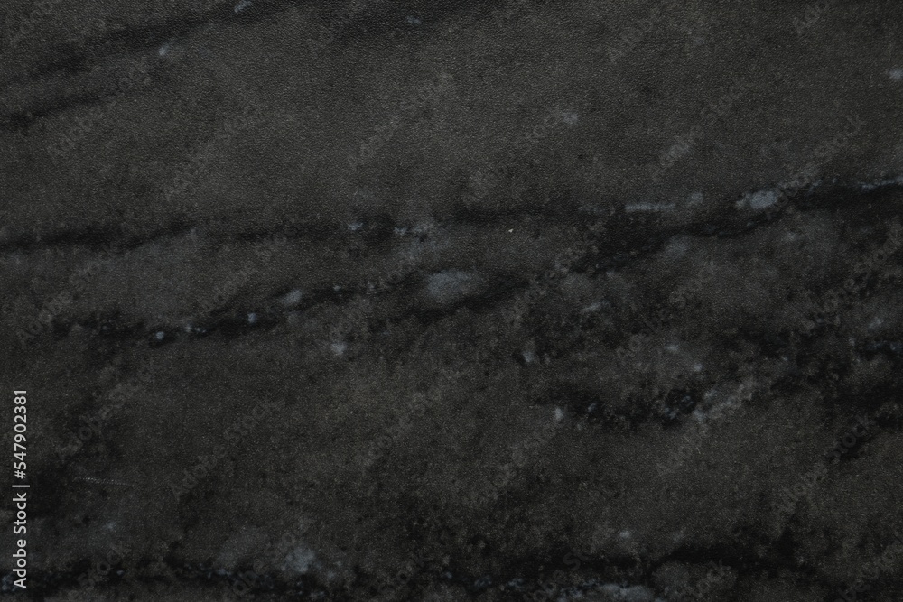 Black marble surface as background, closeup view