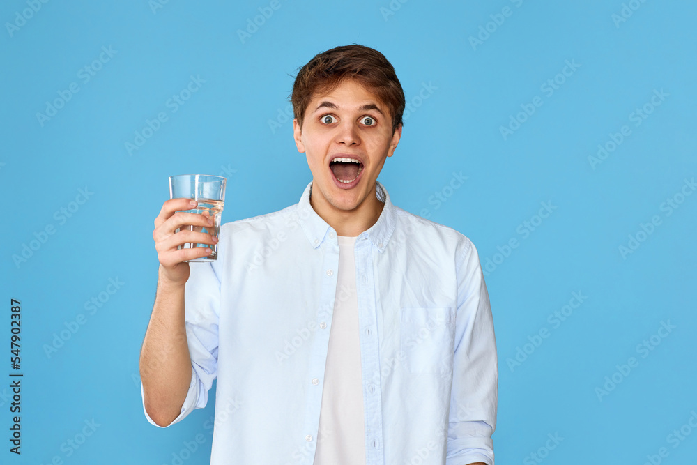 Young handsome man with drinking glass of water Young handsome man with drinking glass of water