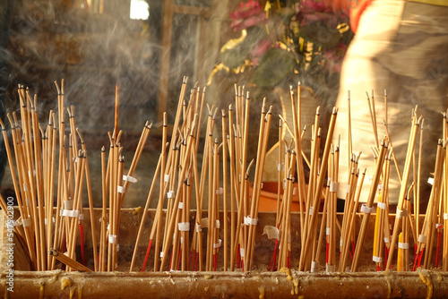 Hand lace incense on joss stick pot to make a wish,Incense that was lit to worship,Make merit for Temple Thailand photo