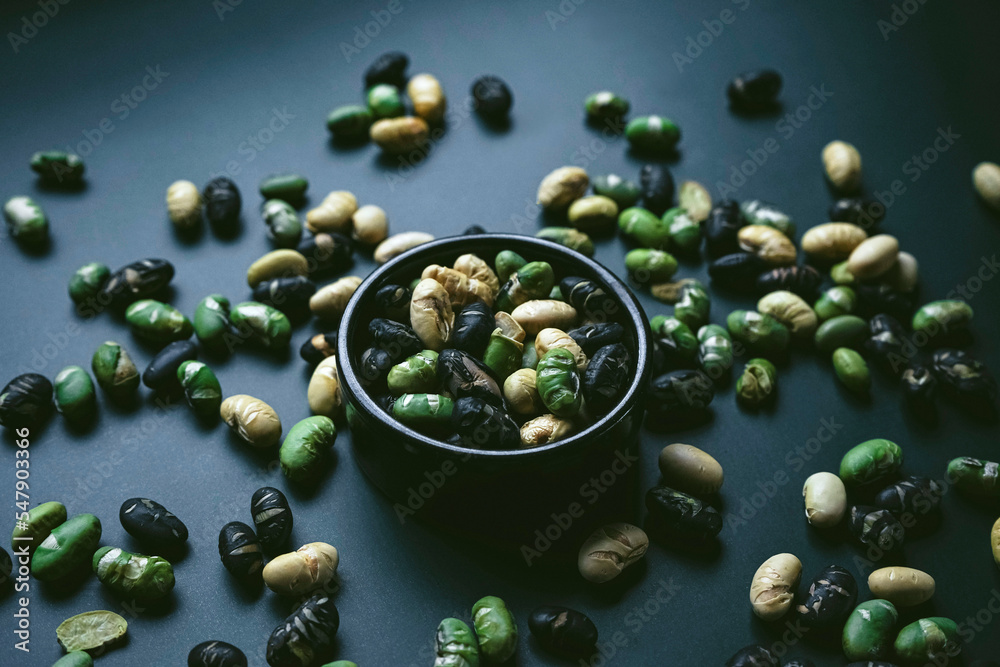 Elegant flat lay in dark tones of three color roasted edamame Elegant flat lay in dark tones of three color roasted edamame