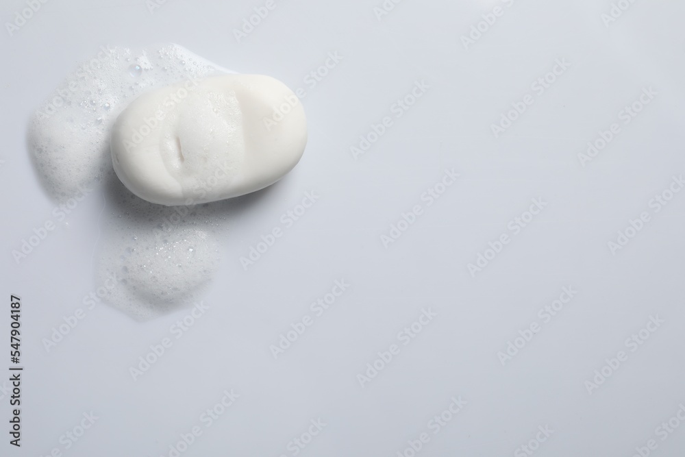 Soap and fluffy foam on white background, top view Soap and fluffy foam on white background, top view