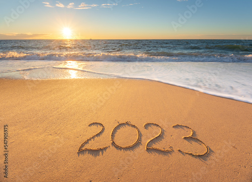 2023 year on the sea shore during the sunset.