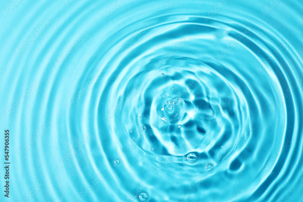 Closeup view of water with rippled surface on light blue background Closeup view of water with rippled surface on light blue background