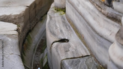 Water drop persistence cuts through marble, continuity concept, dripping water hollows out marble, motivation concept, 4k 60 fps video with the tripod, ablution area in the mosque courtyard