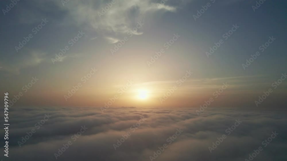 View from the cockpit of an airplane above the clouds at sunrise. View from the cockpit of an airplane above the clouds at sunrise.
