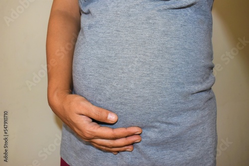 Seven months Pregnant Woman belly closeup