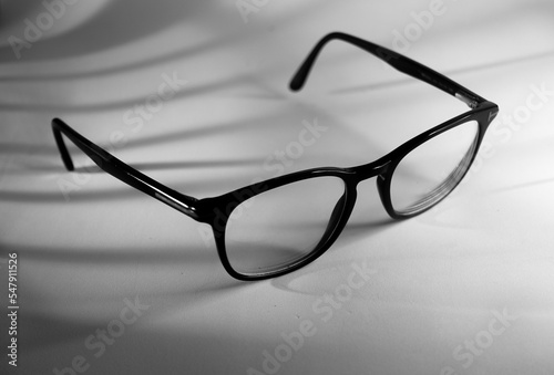 Fototapeta Naklejka Na Ścianę i Meble -  glasses in shadow, black and white photography 