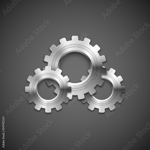 Metallic cogwheels with brushed surface on gray background