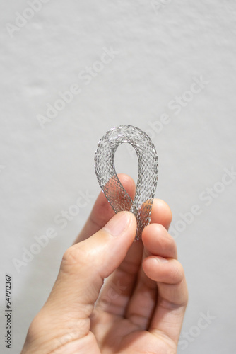 person holding a flexible vascular stent