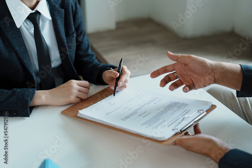 Guarantee, mortgage, agreement, contract, sign, the customer is signing the contract document as evidence to the real estate agent or bank officer according to the agreement according to the document