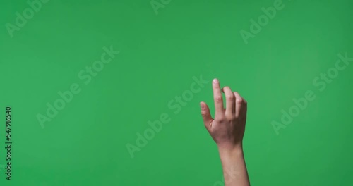 Female hand swiping to virtual screen on chroma key background, closeup