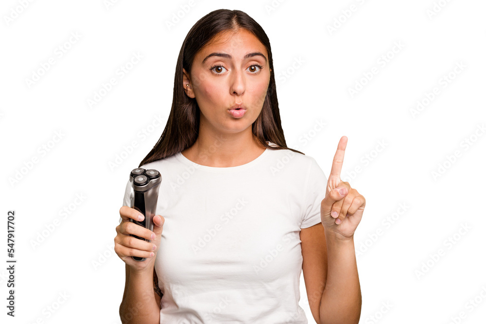 Young caucasian woman holding a razor isolated having some great idea, concept of creativity. Young caucasian woman holding a razor isolated having some great idea, concept of creativity.