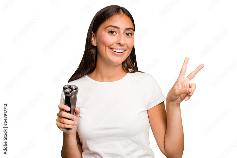Young caucasian woman holding a razor isolated joyful and carefree showing a peace symbol with fingers. Young caucasian woman holding a razor isolated joyful and carefree showing a peace symbol with fingers.