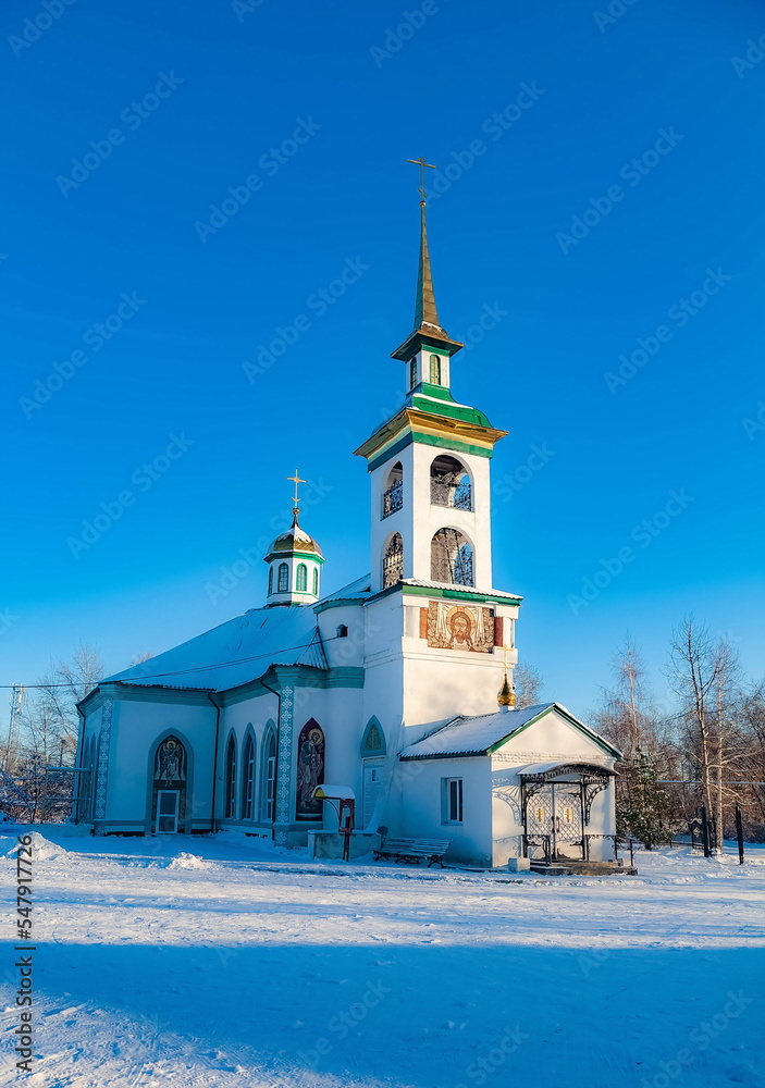 Fototapeta premium The building of the Orthodox church against the blue sky in winter. Russia. Ural. Polevskoy