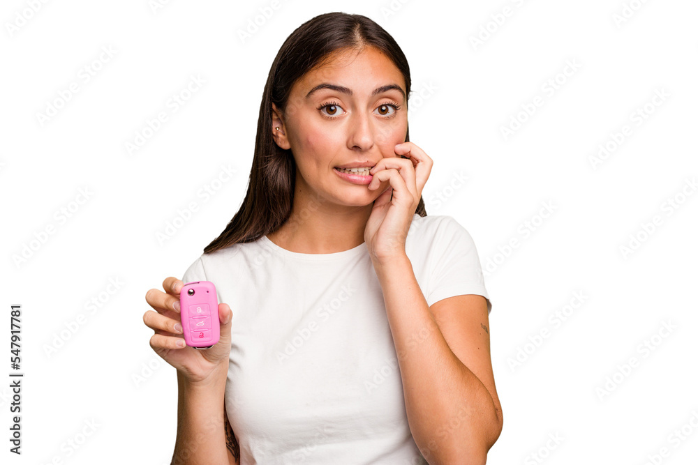 Young caucasian woman holding a car keys isolated biting fingernails, nervous and very anxious. Young caucasian woman holding a car keys isolated biting fingernails, nervous and very anxious.